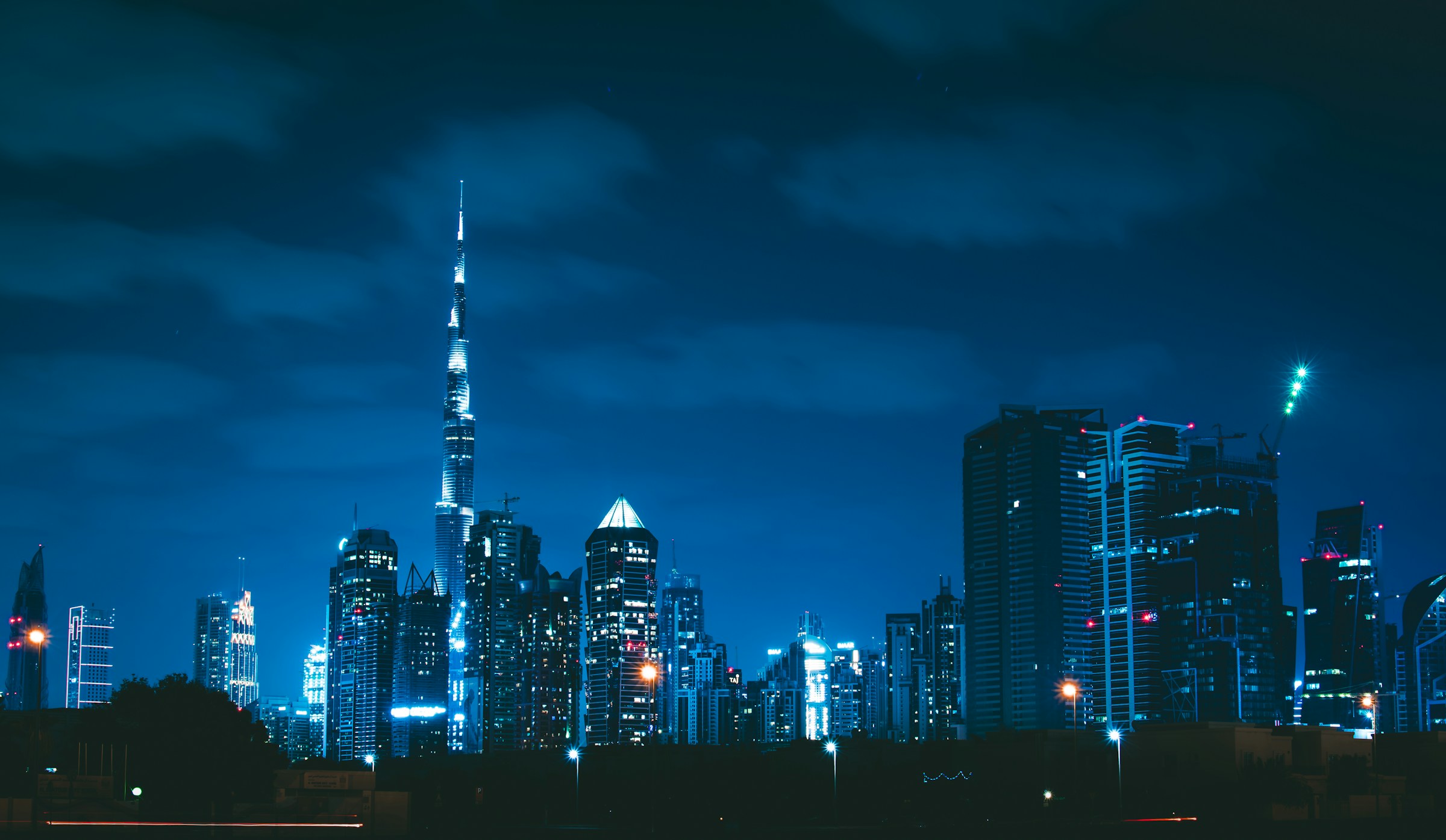 Dubai skyline and Burj Khalifa at blue hour, viewed from the Dubai Canal